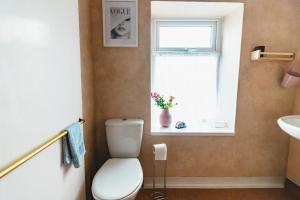 een badkamer met een toilet en een raam bij A Perfect 1BD Getaway in Aberdare, South Wales in Aberdare