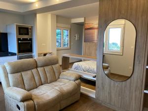 a living room with a couch and a mirror at TOURIÑÁN MAR in Muxia