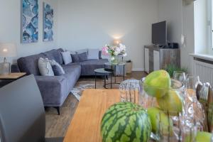 a living room with a couch and a table at Ferienwohnung Königsmann in Strandnähe in Westerland