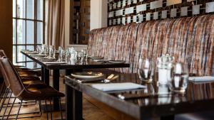 a row of tables in a restaurant with glasses at Midlands Park Hotel in Portlaoise