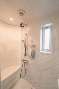 a bathroom with a shower and a tub and a sink at iyooo - Vacation STAY 12867 in Nanao