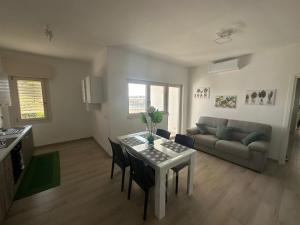 a living room with a table and a couch at Casa Valeria in Taranto
