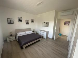 a bedroom with a bed and a dresser in it at Casa Valeria in Taranto