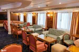 a restaurant with couches and tables and chairs at M/S Nile Quest Cruise - 4 or 7 Nights From Luxor each Monday and 3 or 7 Nights From Aswan each Friday in Luxor