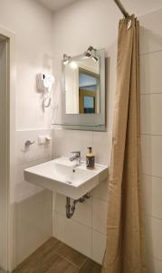 a bathroom with a sink and a mirror at Sleep1c in Hamburg