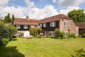 a large brick house with a grass yard at Luxury Home, 20 Mins From Goodwood Pet Friendly! in Stoughton