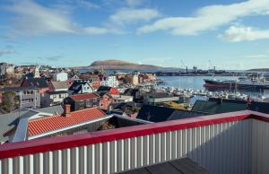 a view of a city with a harbor and boats at Downtown - Retro Decor - Stunning Views - Terrace in Tórshavn