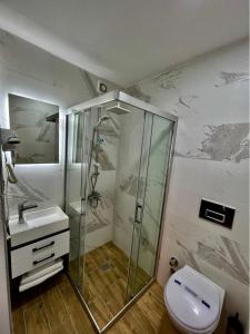 a bathroom with a shower and a toilet and a sink at Miro Mara Boutique Hotel & Lounge Bar in Edremit