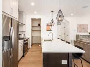 a kitchen with a white counter top and a refrigerator at Modern Luxury 4BR 3 5BA Oasis in Historic Old Town East PD in Columbus