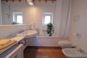 a bathroom with two sinks and a tub and a toilet at Collina di Verona Borgo San Mattia in Verona