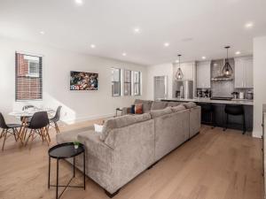 a living room with a couch and a kitchen at Modern Luxury 4BR 3 5BA Oasis in Historic Old Town East PD in Columbus +33 photos