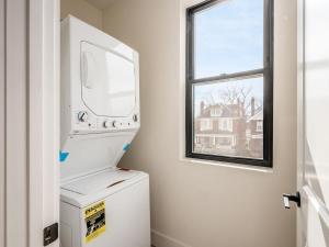 a washer and dryer in a room with a window at Modern Luxury 4BR 3 5BA Oasis in Historic Old Town East PD in Columbus