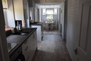 a kitchen with a hallway leading to a dining room at Lovely Garden Cottage in Snettisham in Snettisham