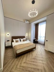 a bedroom with a large bed and a large window at Five Hotel in Astana