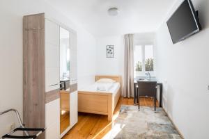 a room with a bed and a desk and a tv at WG-Haus in Landshut
