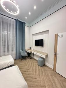 a hotel room with a desk and a tv at Five Hotel in Astana