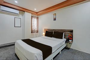 a bedroom with a large bed and a window at OYO Sri Sai sevalal comfort's in Bangalore