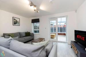 a living room with a couch and a tv at Wharf House TSAC in Stockton-on-Tees