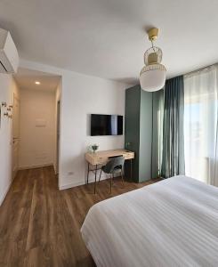 a bedroom with a bed and a desk and a television at B&B Domus Teano Luxury Rooms in Rome