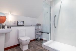 a bathroom with a toilet and a glass shower at Crubenbeg Country House in Newtonmore +16 photos