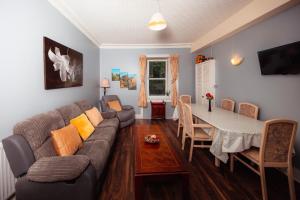 a living room with a couch and a table at Super Central 4bedroom Apartment at the Meadows in Edinburgh