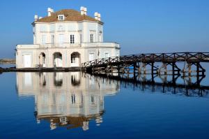 a white house on a bridge in the water at Casa Vacanze Argento in Bacoli