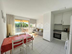 a kitchen and dining room with a table and chairs at Apartamento frente al mar en La Llosa Edif Olimpic 103A - INMO22 in Cambrils