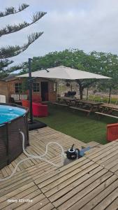 a patio with an umbrella next to a pool at CASA DE LA PRADERA in Arucas