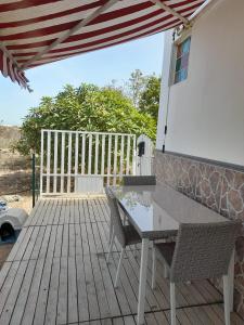 a patio with a table and chairs on a deck at CASA DE LA PRADERA in Arucas