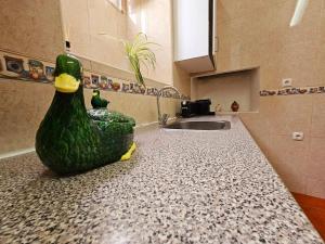 a kitchen with a statue of a chicken on a counter at Casa do Castelo III in Arraiolos