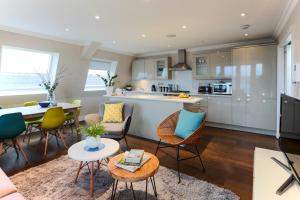 a kitchen and living room with a table and chairs at Madison Hill - White Hill House 5 - 3 bedroom flat in London