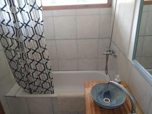 Un baño con bañera, lavabo y ducha. en Mebruck Lago Puelo, en Lago Puelo 21 fotos más