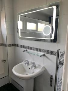 a bathroom with a sink and a mirror at Impeccable 3-Bed House in Birmingham in Birmingham