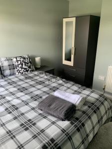 a bedroom with a bed with two towels on it at Impeccable 3-Bed House in Birmingham in Birmingham