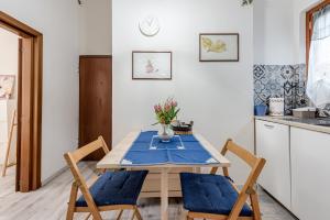a kitchen with a wooden table with chairs and a table at Nel cuore del rione del Drago in Pistoia +13 photos