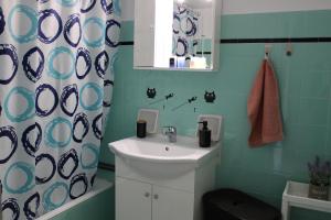 a bathroom with a sink and a shower curtain at Mona Hause in Athens