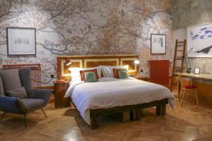 a bedroom with a bed and a desk and a chair at Brody House - boutique hotel in Budapest