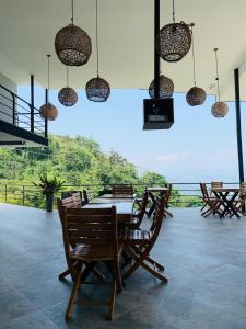a dining room with a table and chairs and lights at Zoi Eco Hotel in Manizales