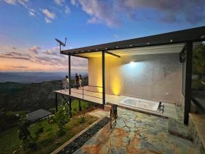 a house with a bath tub on top of a mountain at Zoi Eco Hotel in Manizales