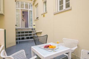 a table with a bowl of fruit on a patio at Apartament with a terrace in the heart of Lisbon, 300 in Lisbon