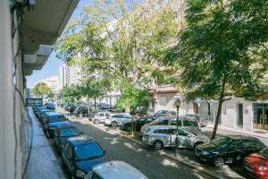 a row of parked cars on a city street at Apartament with a terrace in the heart of Lisbon, 300 in Lisbon