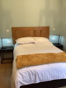 a bedroom with a large bed with two night stands at Aachen Hotel in Liverpool