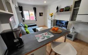 a kitchen and living room with a counter and a table at Haus Mundo La Marina Urbanisation in San Fulgencio