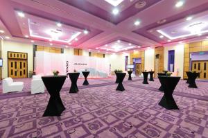 a room with black tables and a purple ceiling at Riu Plaza Panamá in Panama City +37 photos