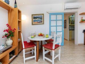 kuchnia i jadalnia ze stołem i krzesłami w obiekcie Apartment Les Oranetes by Interhome w mieście Llança