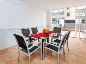 a dining room table with chairs and a bowl of fruit on it at Holiday Home Del Sol by Interhome in Salou