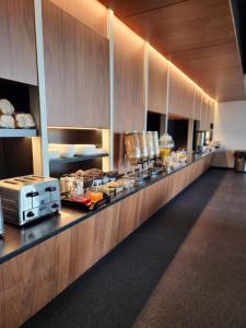 a buffet line in a restaurant with food on it at Grand Times Hotel Laval - Centropolis in Laval