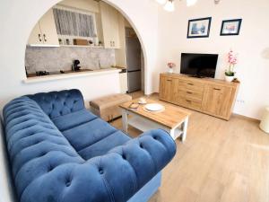 a living room with a blue couch and a table at Apartment Antoine by Interhome in Marina