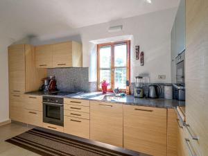 a kitchen with wooden cabinets and a sink and a window at Holiday Home Casa Diana by Interhome in Bibali