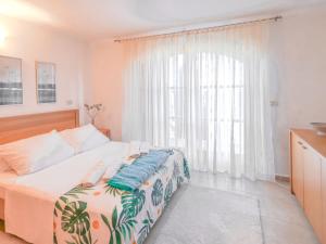 a bedroom with a bed and a large window at Holiday Home Casa Diana by Interhome in Bibali